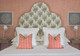 Upholstered headboard in Bouquet fabric by Barron and Larcher, featuring a floral and geometric pattern in dark indigo with terracotta accents. Set against a terracotta bedroom interior designed by Claudia Starr.